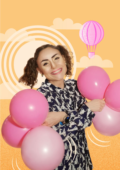 Girl holding balloons in her hands. The character is depicted on a sunny background. A hot air balloon can be seen on the sky.