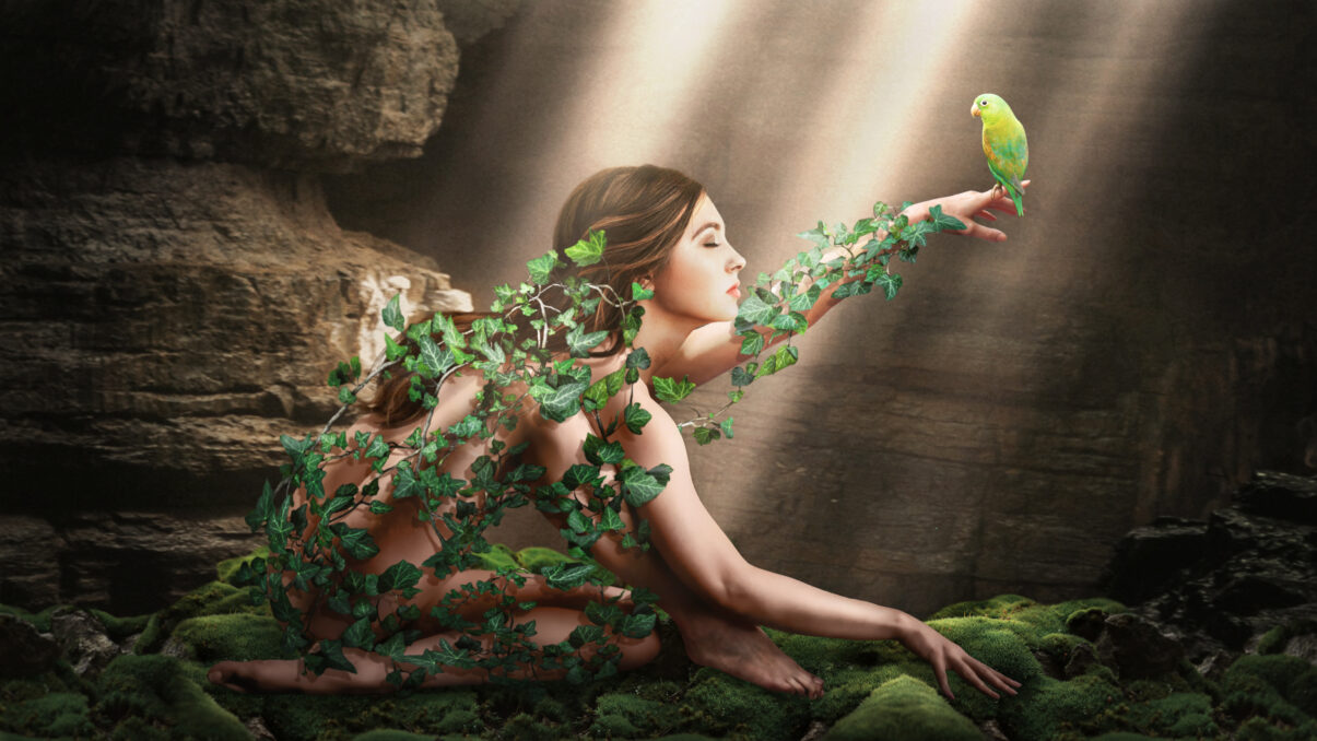 Inspired by nature Screensaver Design for BenQ Design Vue depicting a young woman covered in ivy and holding a parrot on here finger, in a cave under a beam of light