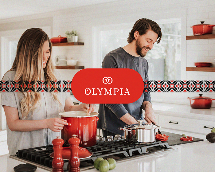 Rebranding Olympia mockup primary logo - behind the logo there are a young women and man cooking in the kitchen - passion project by ©Loredana Codau