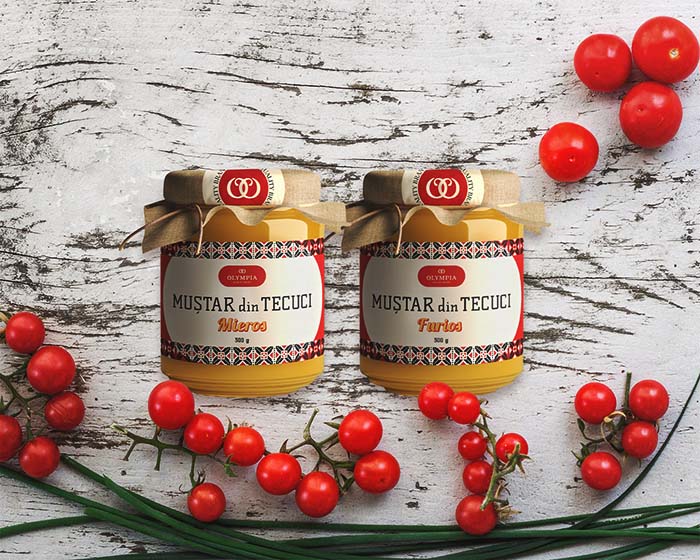 Olympia Mustar din Tecuci Mustard from Tecuci mockup rebranding two jars of mustard surrounded by tomatoes on a table - passion project by ©Loredana Codau