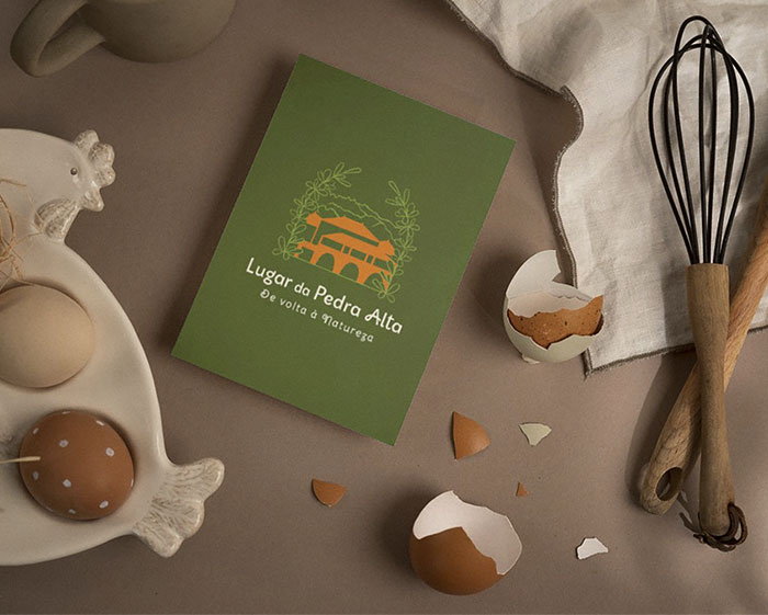 Lugar da Pedra Alta card mockup depicted between eggs and kitchen objects