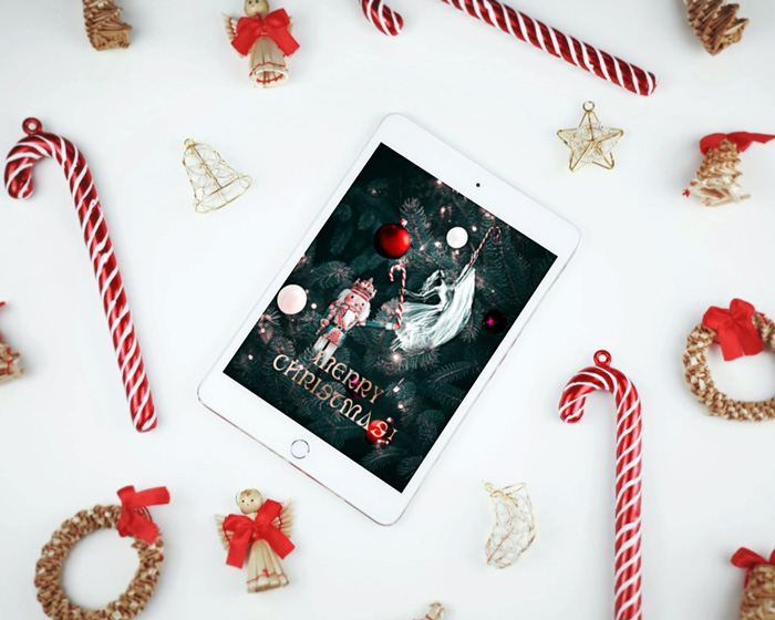Christmas card mockup depicting a Christmas love story presented on an Ipad, places on a flat surface between candy canes and Christmas ornaments