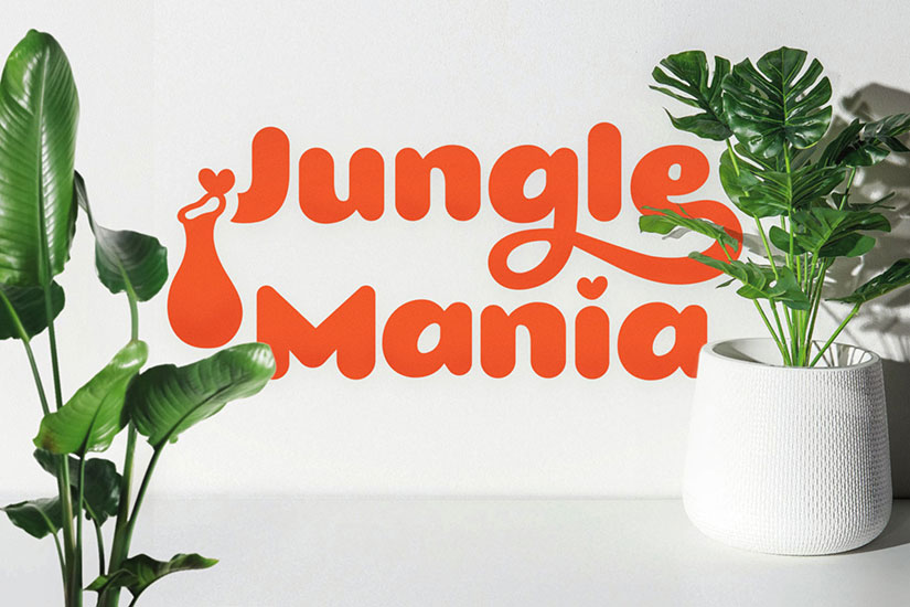 Tropical plant shop logotype Jungle Mania, depicted oversized behind a Monstera Delicioasa plant and a banana tree.