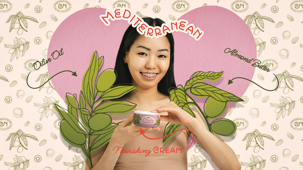 A young girl smiling is holding the Mediterranean Nourishing Cream in her hand. The girl is surrounded by brand illustrations depicting almond and olive branches, the ingredients used in the product. Behind her there is depicted a heart. Above her there is written the product line name, Mediterranean, and below the product name Nourishing Cream. On her right and left sides there are written the organic ingredients used in the product.